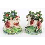 Two English earthenware figures of recumbent sheep and ram, circa 1820-30, in bocage,