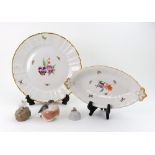 A KPM Berlin porcelain plate and matching oval dish, painted with flowers and insects,