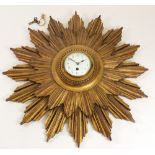 A carved giltwood star burst wall timepiece, early 20th century,