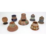 A collection of six Royal Doulton and Doulton Lambeth stoneware match strikes,