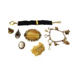 A gold curb link charm bracelet, fitted with eight mostly 9ct gold pendants and charms,