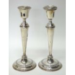 A pair of silver table candlesticks, each of tapering form,