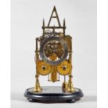 A brass Gothic-style striking skeleton clock By Cox, Islington,