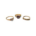 An 18ct gold, ruby and diamond set seven stone cluster ring,