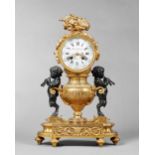 A French ormolu and bronze mantel clock In the Louis XVI style, circa 1880 The case cast as an urn,