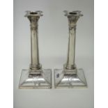 A pair of silver table candlesticks, each designed as a Classical column,