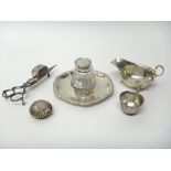 A late Victorian silver inkstand of shaped circular form, having a gadrooned rim,