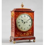 A Regency mahogany and brass-inlaid bracket clock The case with a chamfered pediment surmounted by