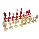 An English stained ivory chess set, 19th century, the Kings and Queens of turned tapering form,