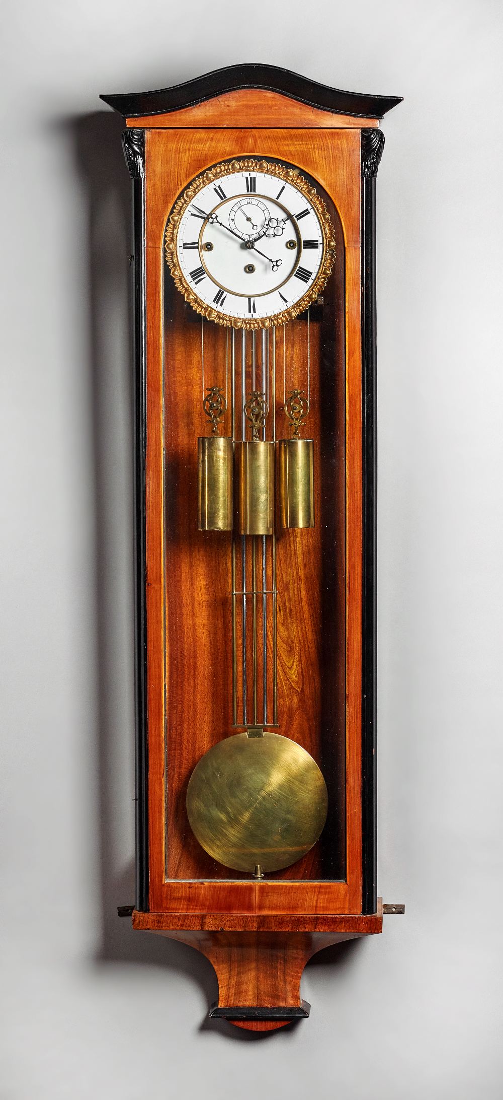 A walnut and ebonised quarter-striking 'Vienna' regulator Last quarter 19th century The case with