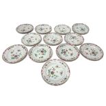 A set of twelve Chinese famille-rose plates, Qianlong, each painted with scattered flowers, (a.