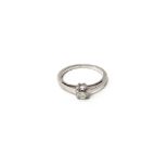 A step cut diamond solitaire ring, on a white metal split section shank,