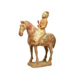 A Chinese pottery model of a horse and rider, Tang Dynasty ,