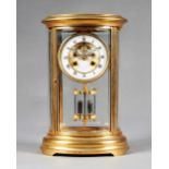 A French ormolu oval four-glass mantel clock Circa 1890 The case with a moulded top and inset with