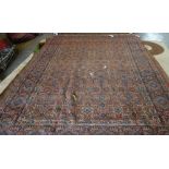 A Tabriz carpet, Persian, the madder field with an allover trellis design,