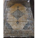 A Ghom silk rug, Persian the plain gold field with a stepped medallion, matching spandrels,