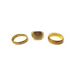 A 22ct gold decorated wedding ring, a 22ct gold plain wedding ring, combined weight 7.