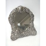 A late Victorian silver mounted heart shaped strut backed mirror,