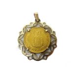 A Czechoslovakia gold dukat 1923, in a gold pendant mount, detailed 585, combined weight 6.3 gms.