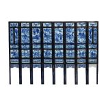 A Chinese blue and white porcelain and ebonised wood eight-fold screen, 19th century,