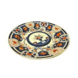 A large Japanese Imari dish, Edo period, painted in the centre with a vase of flowers,