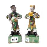 A pair of Chinese biscuit figures, 18th/19th century, each modelled as a man standing,