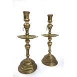 A pair of heavy brass candlesticks, possibly 18th century,