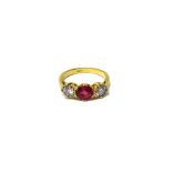 A gold, synthetic ruby and diamond set three stone ring,