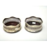 A pair of silver bottle coasters,