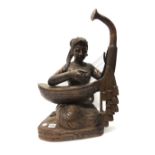 A Burmese wood figure of a musician, 20th century, carved as a seated young woman playing the harp,