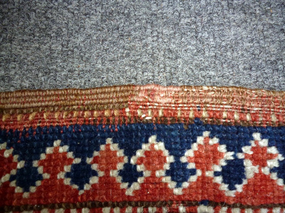 A Karachor Kazak rug, Caucasian, the indigo field with two ivory squares, a madder central cross, - Image 10 of 11