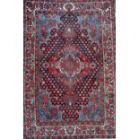 A Bakhtiari rug, Persian, the indigo field with a bold madder medallion,