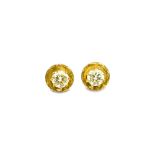A pair of gold and diamond set single stone ear studs, each claw set with a circular cut diamond,