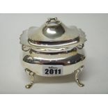 A silver twin handled hinge-lidded tea caddy, of bombe form, raised on four feet,