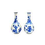 A near pair of Chinese blue and white vases, Kangxi, of elongated pear form,