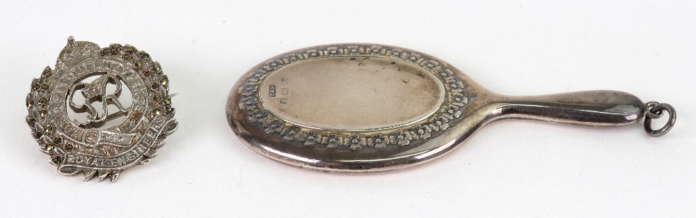 A miniature silver mounted pendant hand