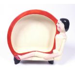 A Clarice Cliff Bizarre baby bowl, the rim moulded with a seated Dutch doll, printed marks,