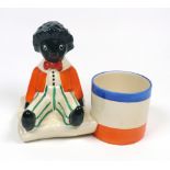 A Clarice Cliff Bizarre Golliwogg pencil pot,