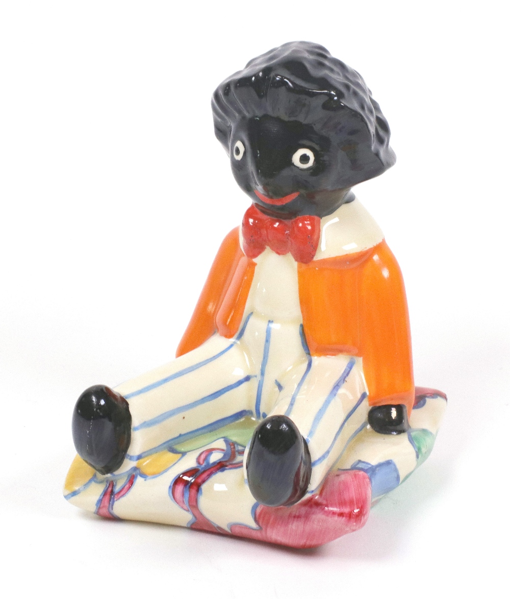 A Clarice Cliff Bizarre 'Autumn Blue' pattern seated Golliwogg bookend, printed marks, 15.5cm.