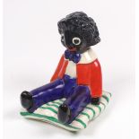 A Clarice Cliff Golliwogg bookend, the seated Golliwogg with red jacket and blue trousers,