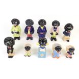 A group of ten stoneware and pottery Golliwogg figures and egg cups.
