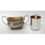 A George III silver twin handled sugar bowl, with partly fluted embossed decoration,