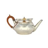 A George III silver teapot, of circular form, with a plain tapering spout,