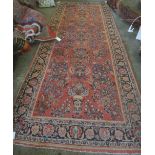 A Sarough Kelleh, Persian, the madder field with an allover design of floral sprays,