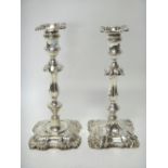 Two late Victorian silver loaded table candlesticks, each in a differing late 18th century design,