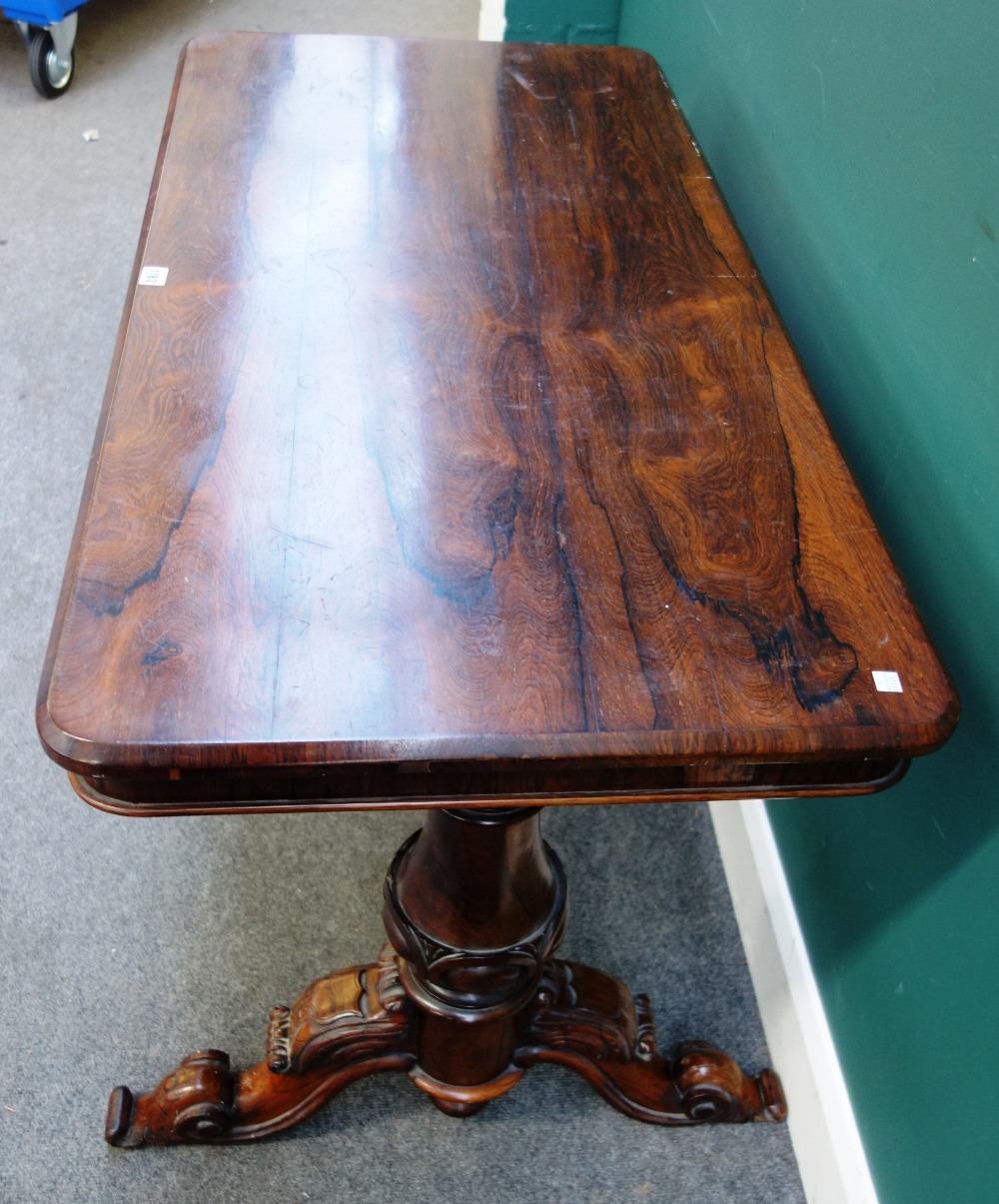 A Victorian rosewood centre table with round rectangular top on pair of carved columns and four - Image 4 of 4