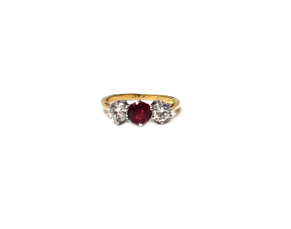 An 18ct gold, ruby and diamond set three stone ring,