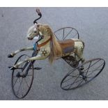 A Victorian and later child's velocipede 'horse' tricycle, dapple grey with leather saddlery,