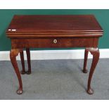 A mid 18th century mahogany triple foldover games table on cabriole supports and club feet,