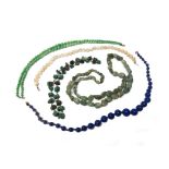 A two row necklace of graduated jade beads, on a boltring clasp and four further bead necklaces,